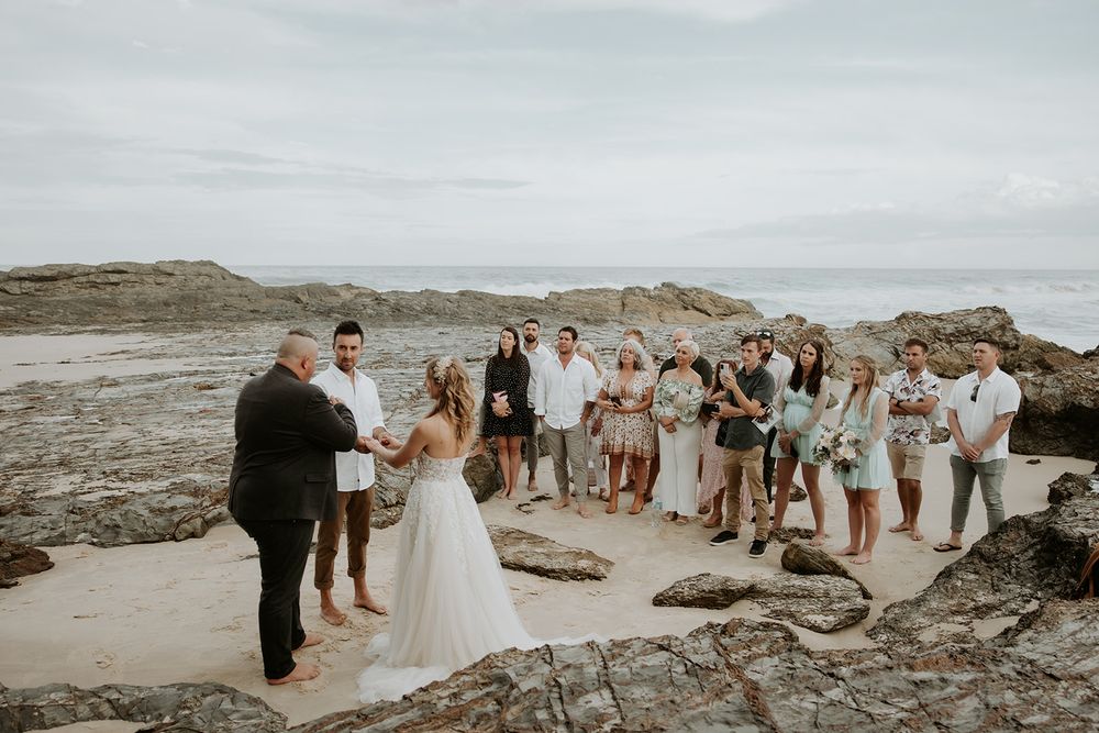 Alana and Nathan with their guests at their Currumbin Rock beach elopement ceremony