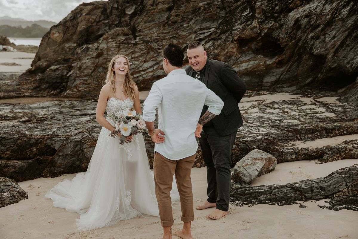 Josh Withers officiating Alana and Nathan’s beach elopement ceremony at Currumbin Rock