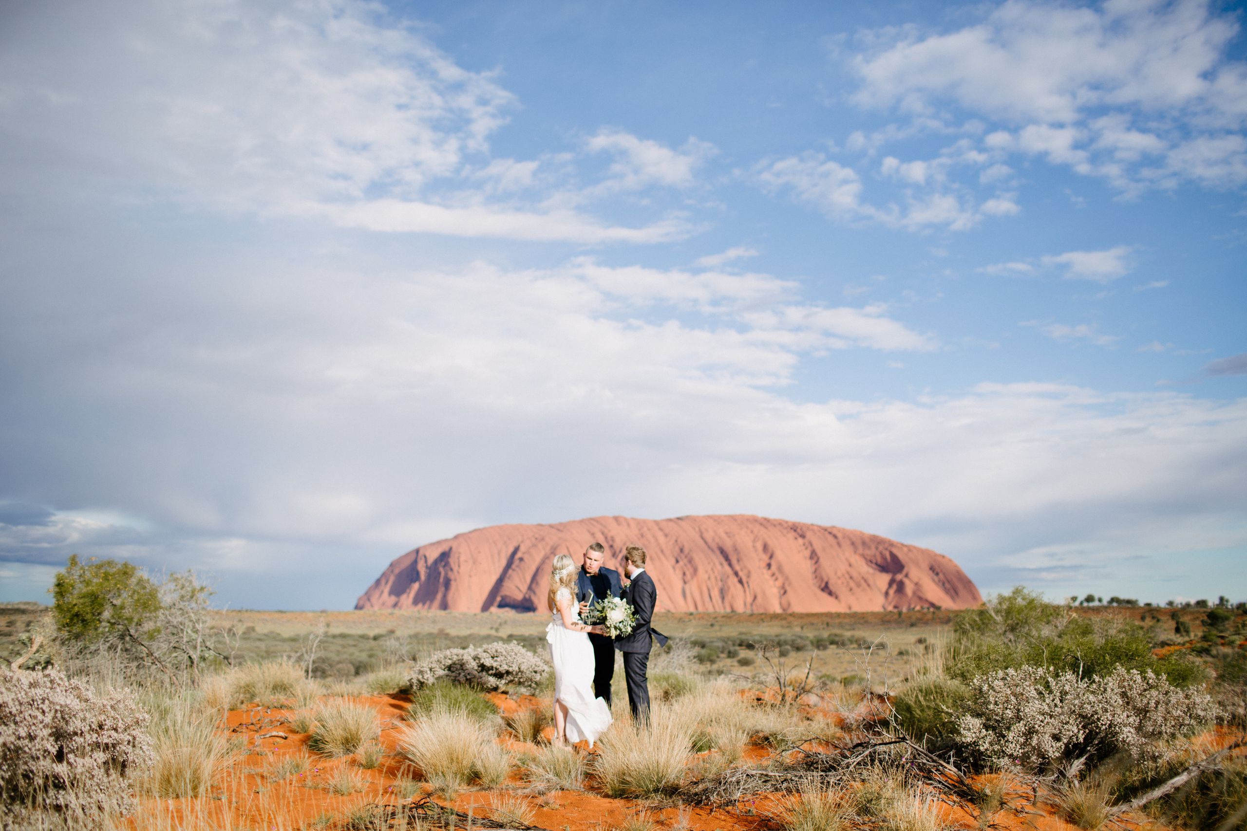 A wedding ceremony with Uluru in the background