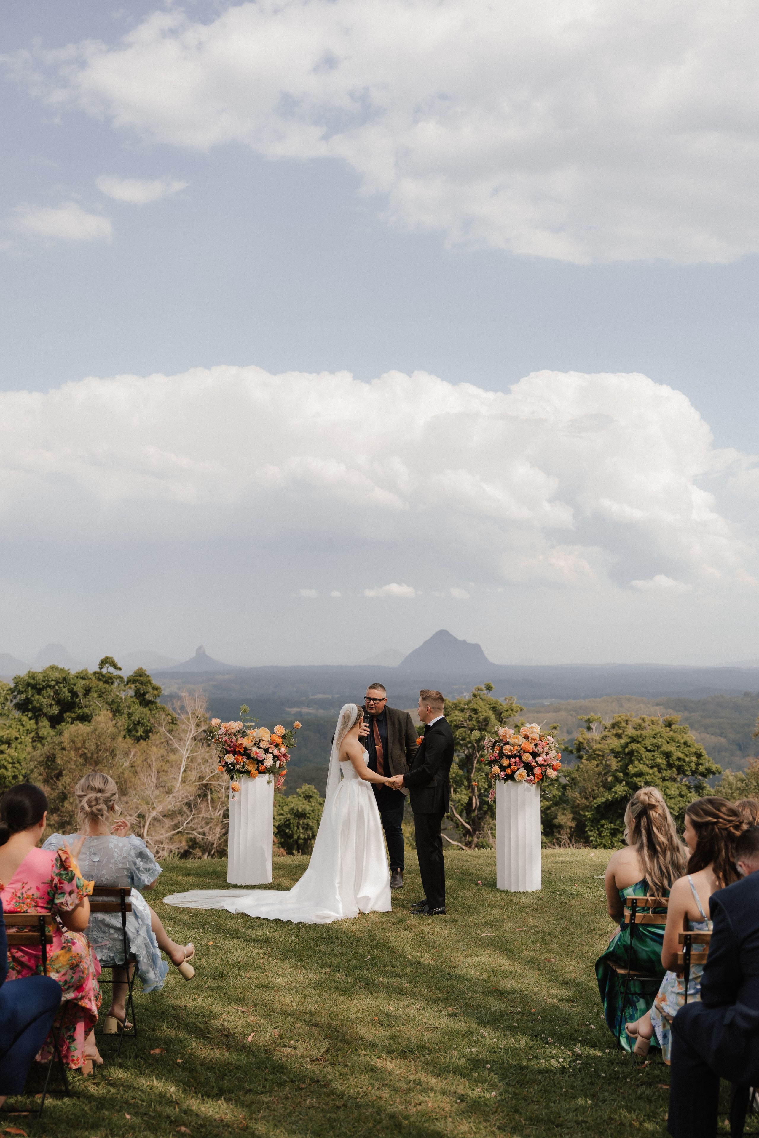 Josh Withers conducting a mountain-view wedding ceremony in Brisbane's hinterland
