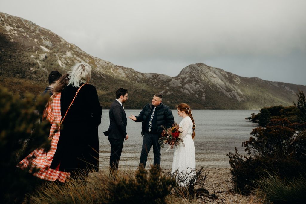 Josh Withers conducting a wedding ceremony beside Dove Lake at Cradle Mountain