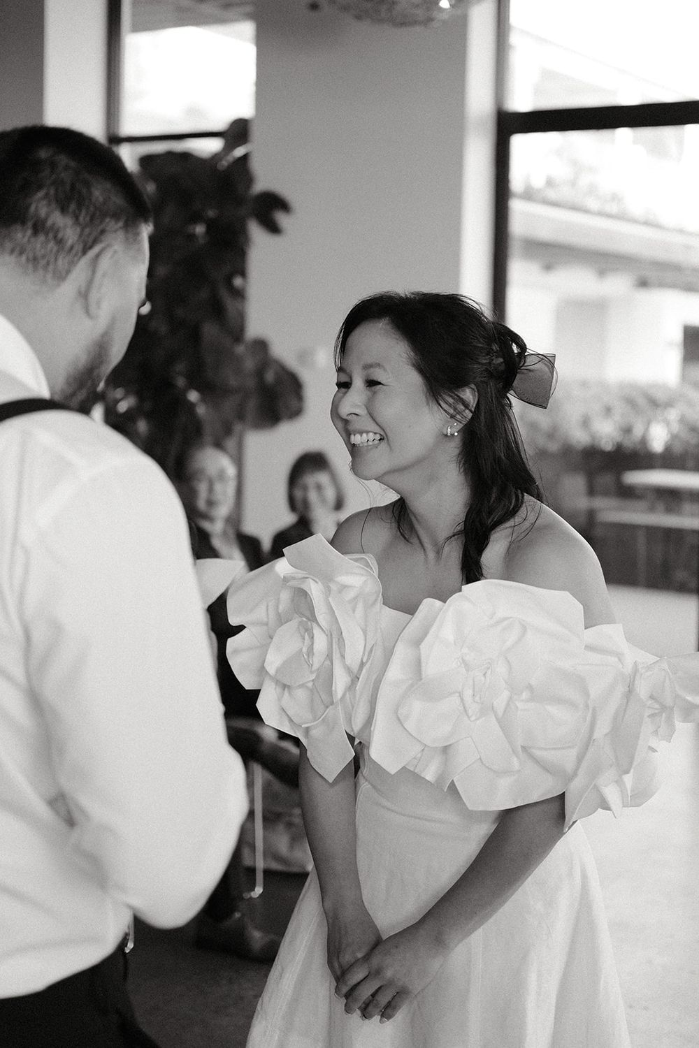 Black and white photograph of Deb looking at Mickey during their vows