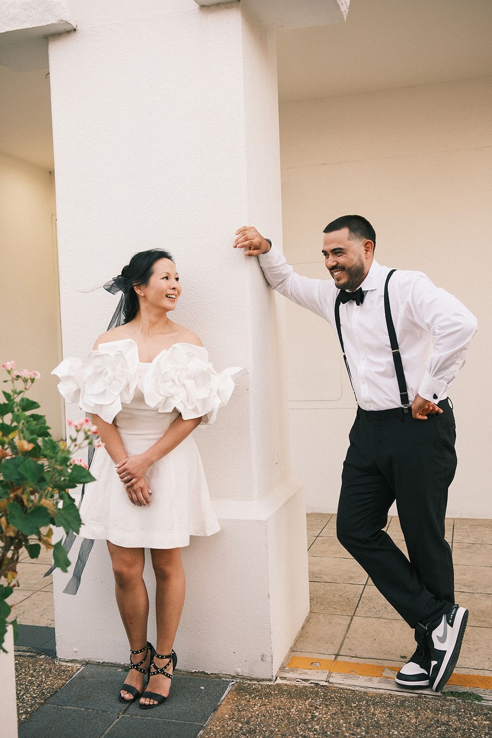 Mickey lifting Deb’s hand as she twirls beside a cream wall