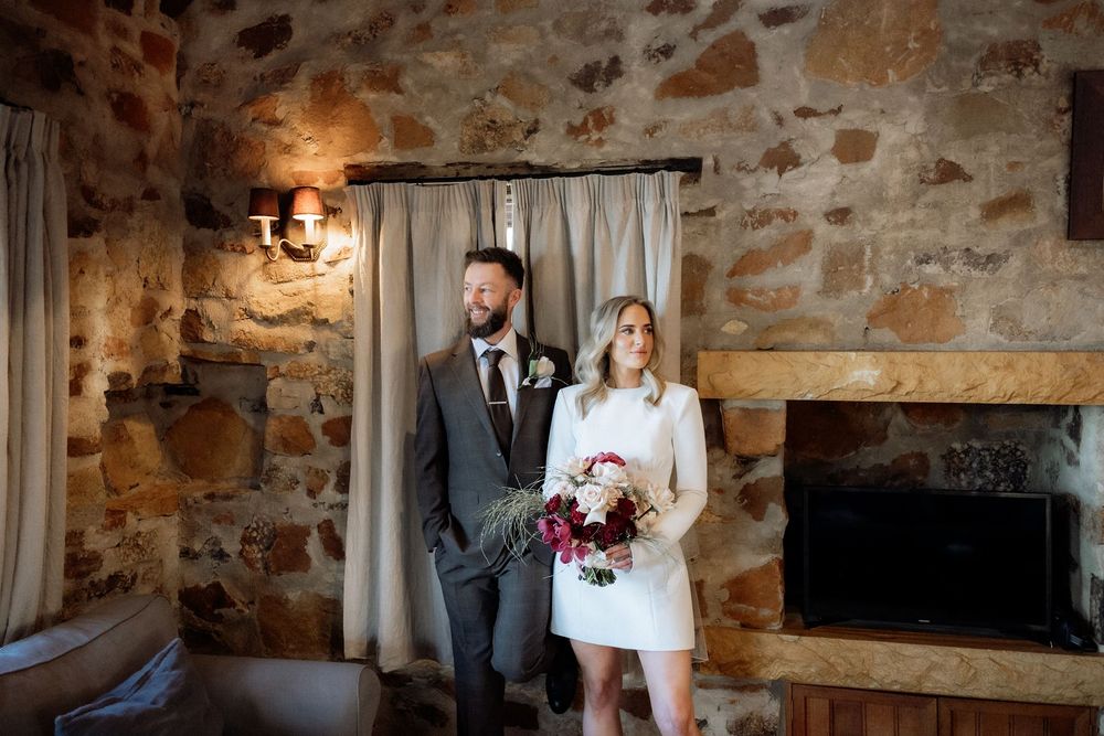 Kaitlyn and Russell laughing together inside their stone cottage at Piermont Retreat