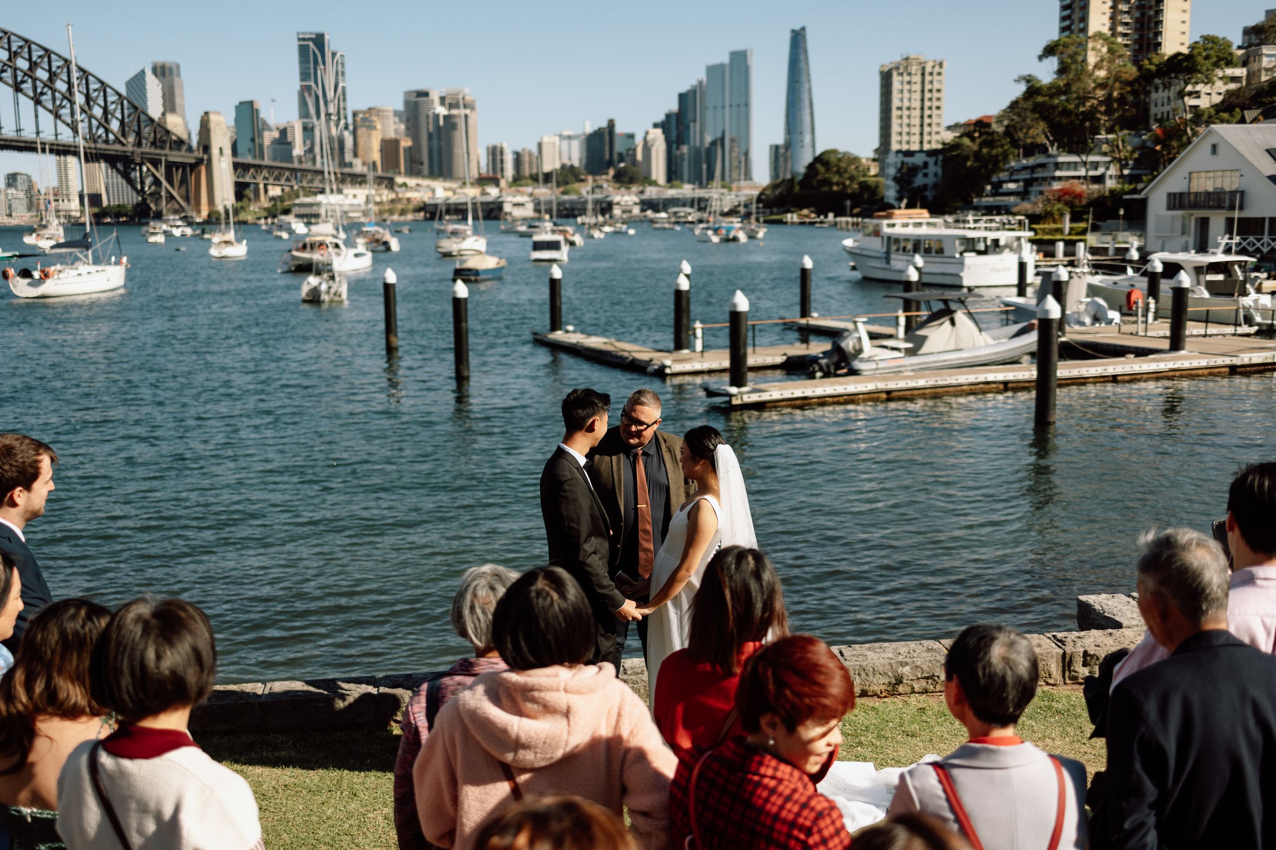 Josh Withers conducting an elopement ceremony beside Sydney Harbour