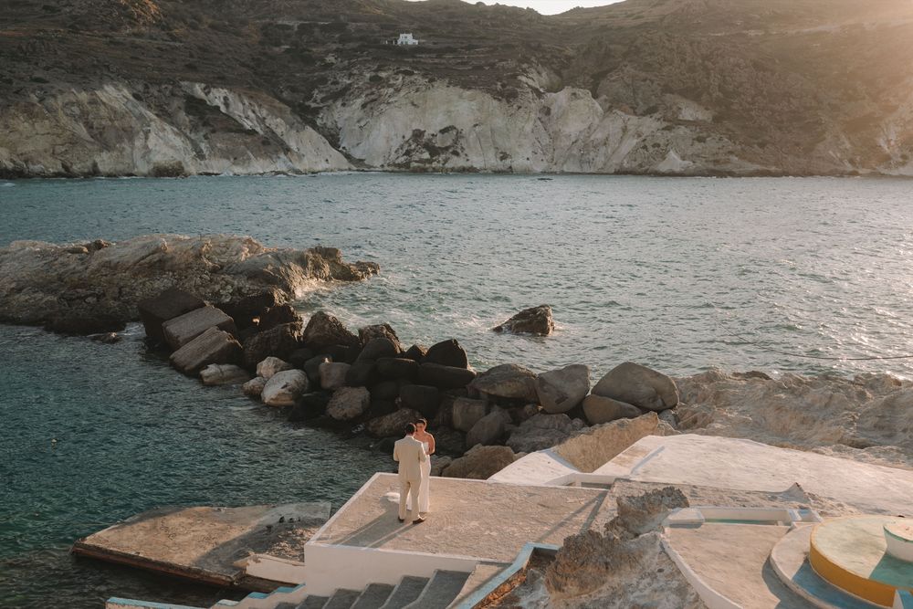 Tiegan and Michael exchanging vows beside the Aegean Sea in Mandrakia, Milos