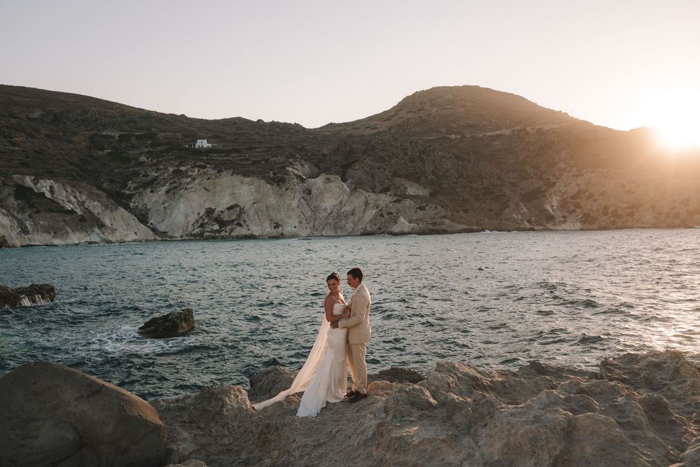 Tiegan and Michael together on the rocky coastline at Sarakiniko, Milos