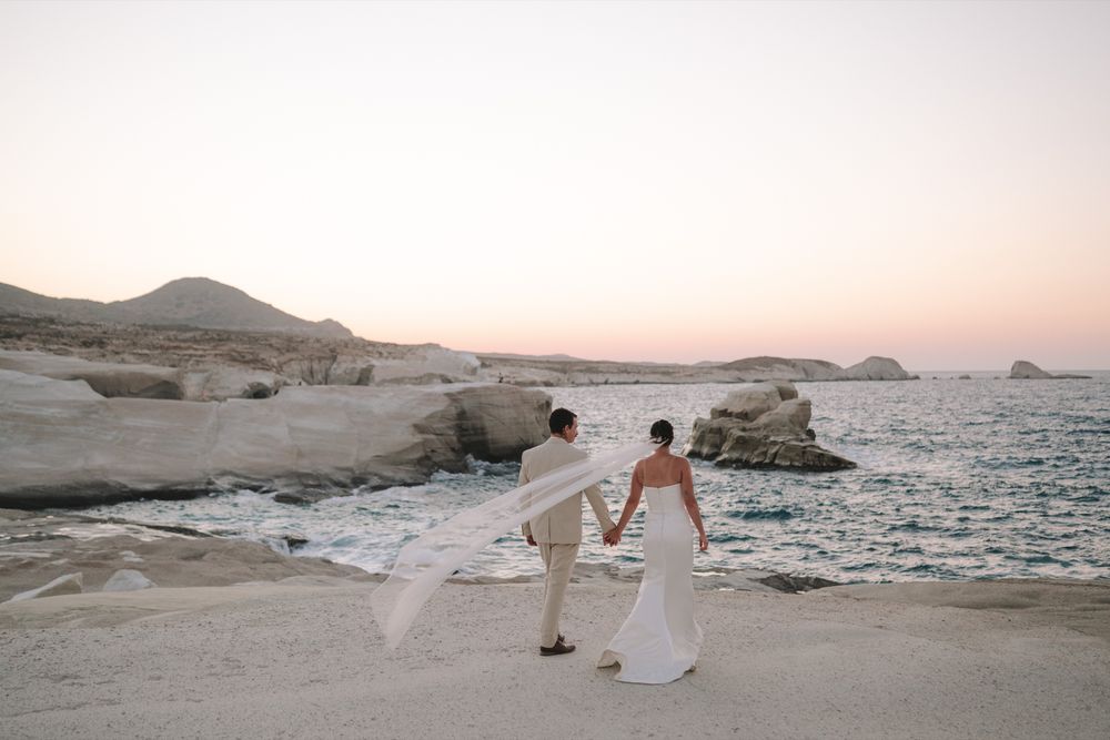 Tiegan and Michael walking beside the Aegean Sea at Sarakiniko Beach, Milos